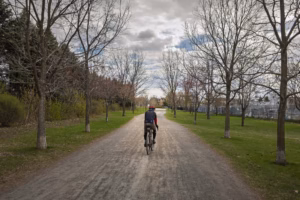 Un cycliste parcourt les sentiers du parc Frédéric-Back, profitant d'une balade active au cœur de cet espace vert montréalais réhabilité.